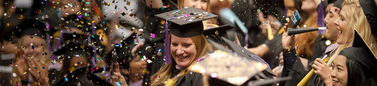 Student celebrate with confetti at Commencement